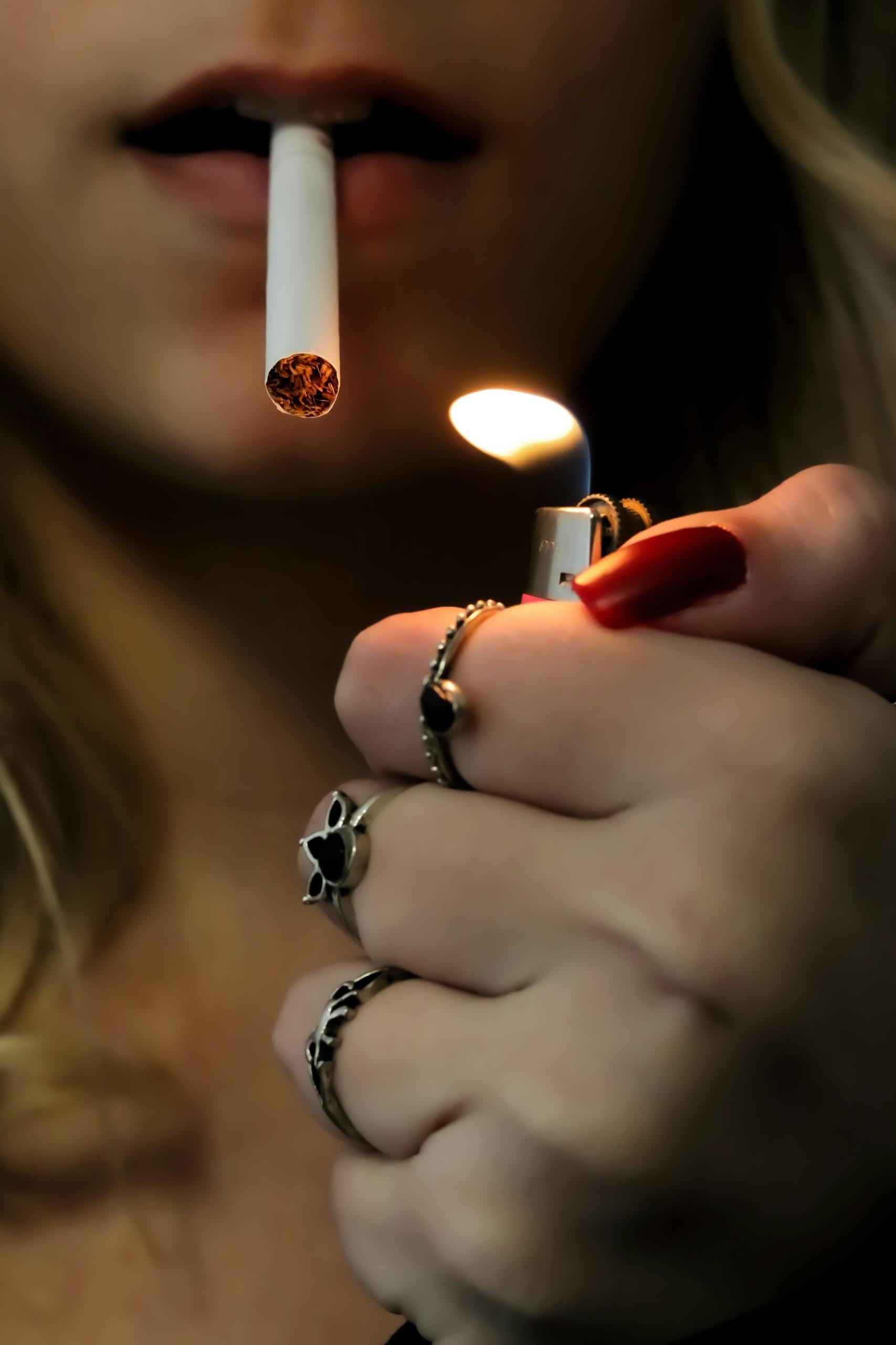 A close-up image of a woman, stressed lighting a cigarette - does smoking relieve stress Melbourne hypnotherapy
