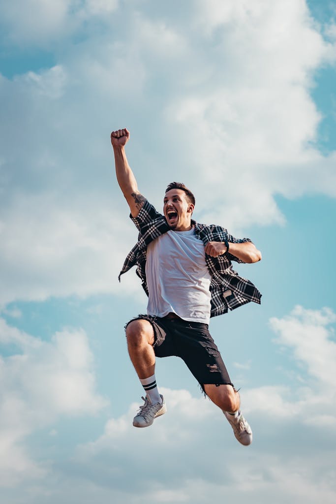Melbourne Hypnosis Quit Smoking Program | Quit Fast, Naturally, and Permanently (2025 Guide) 2 A joyful young man jumps midair with clouds and blue sky in the background, exuding energy and freedom.