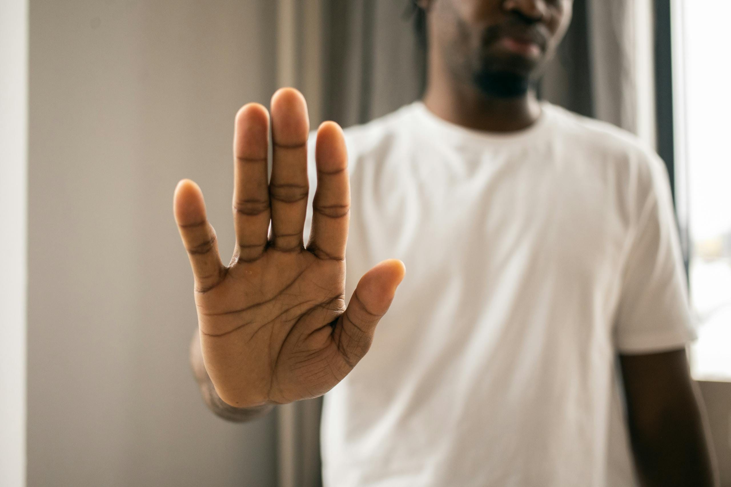 Man raising hand to decline cigarette - social smoker health risks Melbourne hypnotherapy