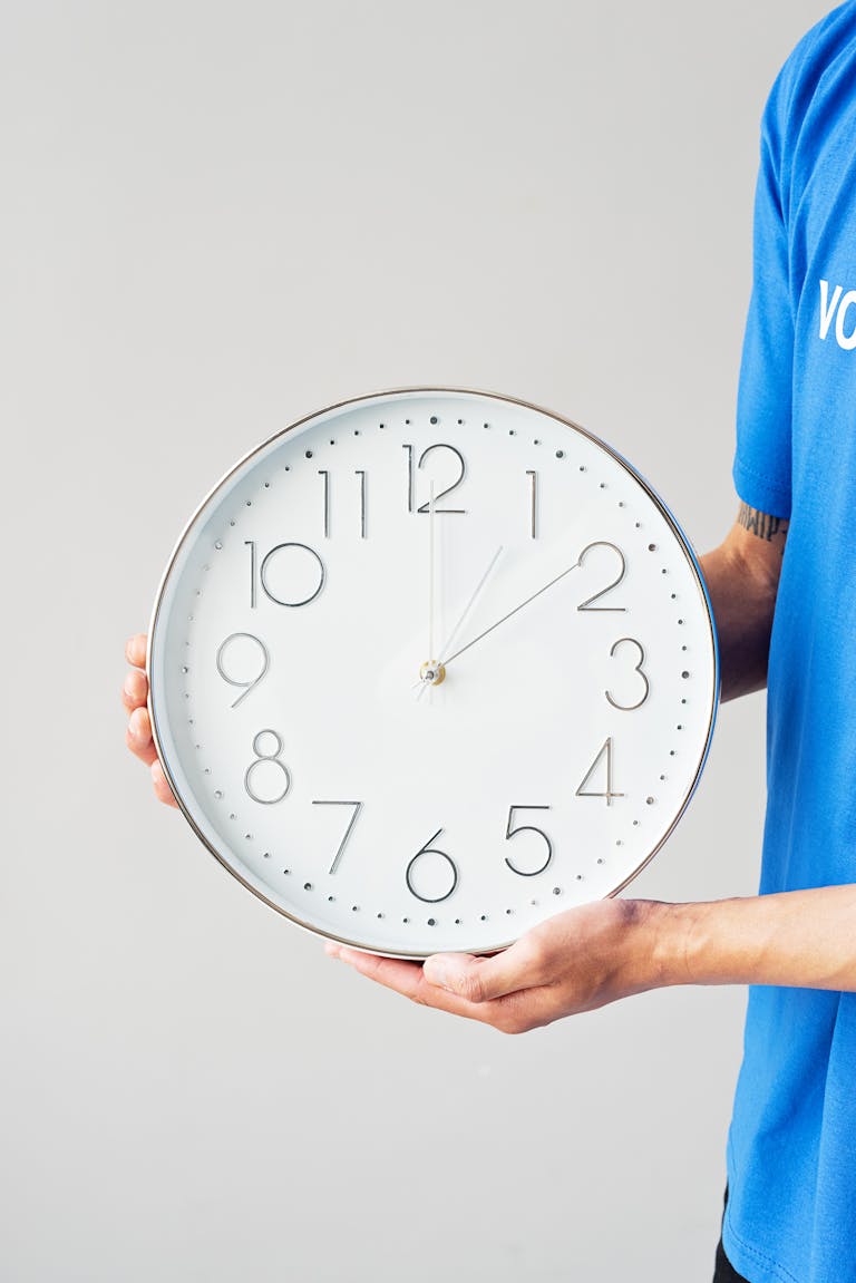 Doctor holding clock representing body after quitting smoking timeline and health recovery