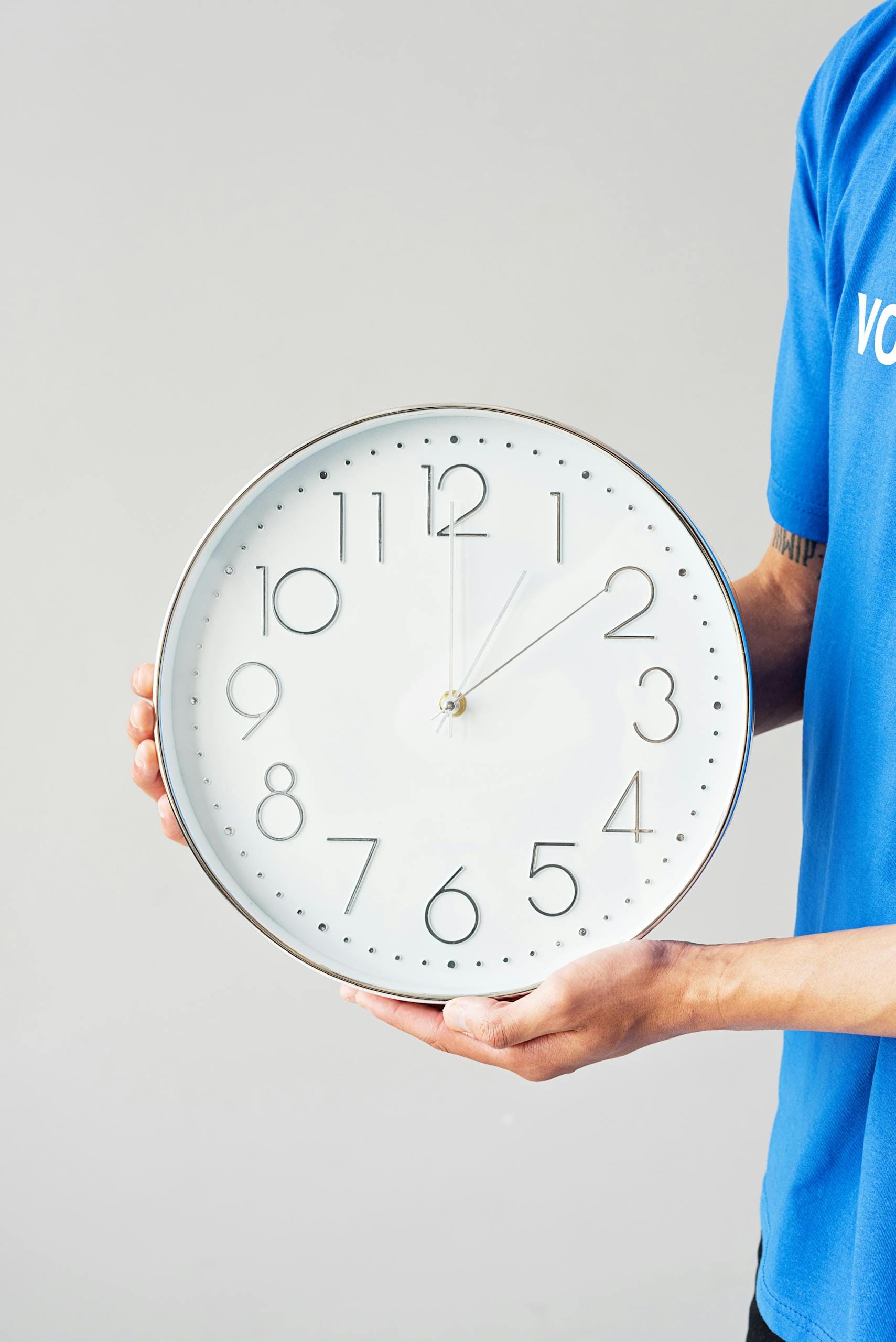 Doctor holding clock representing body after quitting smoking timeline and health recovery