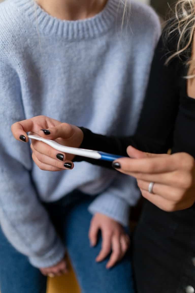 Couple looking concerned holding negative pregnancy test - smoking and fertility Melbourne hypnotherapy