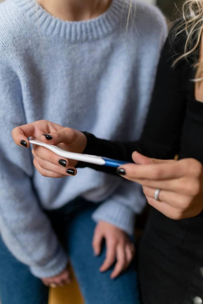 Couple looking concerned holding negative pregnancy test - smoking and fertility Melbourne hypnotherapy